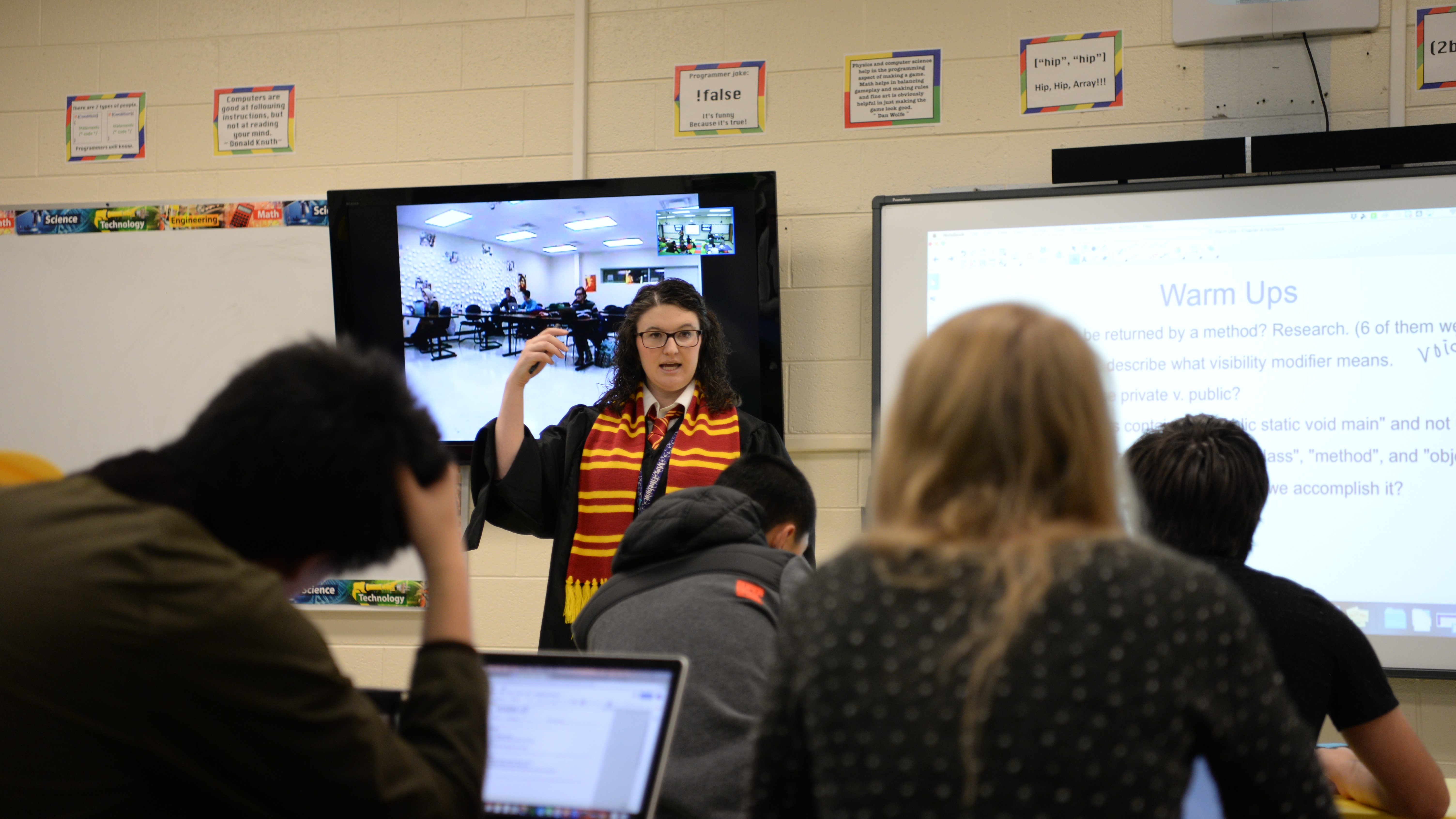 Math teacher Brandi Finchum talks about coding with her class at Farragut High School, while students from West High School watch through a video conference. 